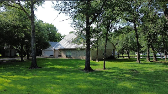 11683 Lakeshore Dr, Thornton, TX 76687 - view of grassy yard with an attached garage