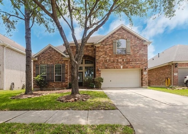 4615 Long Climb Cyn, Humble, TX 77396 - traditional-style home featuring a garage, brick siding, driveway, and a front yard