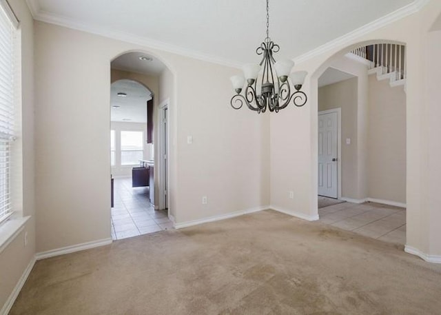 4615 Long Climb Cyn, Humble, TX 77396 - carpeted empty room featuring ornamental molding, a chandelier, arched walkways, and baseboards