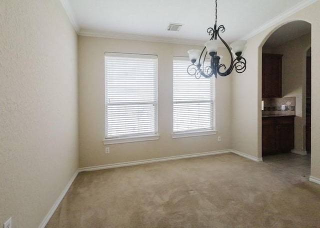 4615 Long Climb Cyn, Humble, TX 77396 - unfurnished dining area featuring light carpet, crown molding, arched walkways, a chandelier, and baseboards