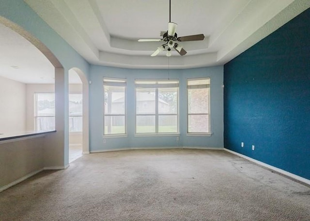 4615 Long Climb Cyn, Humble, TX 77396 - carpeted spare room with ceiling fan, a tray ceiling, baseboards, and arched walkways