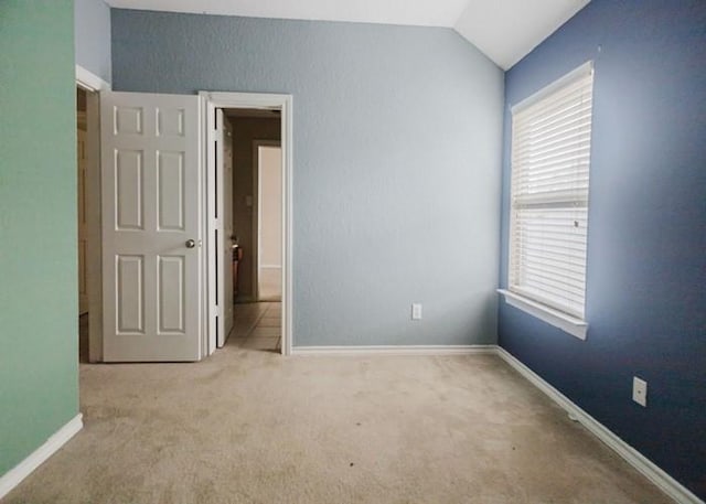 4615 Long Climb Cyn, Humble, TX 77396 - carpeted empty room featuring vaulted ceiling, plenty of natural light, and baseboards