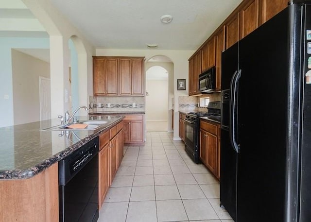 4615 Long Climb Cyn, Humble, TX 77396 - kitchen featuring black appliances, arched walkways, backsplash, a sink, and light tile patterned floors