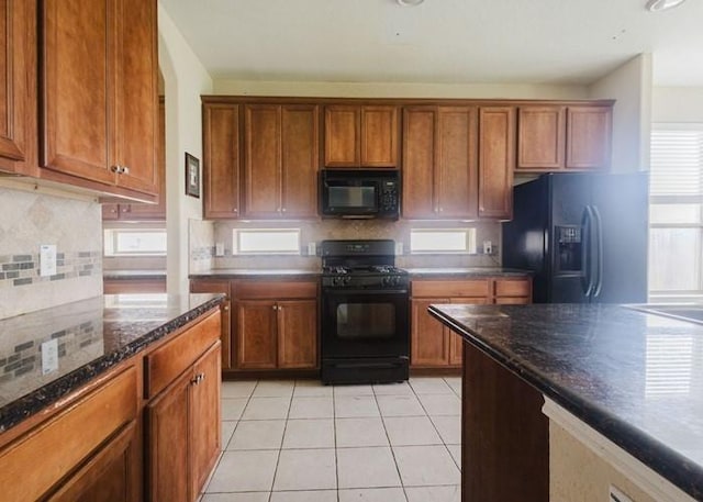 4615 Long Climb Cyn, Humble, TX 77396 - kitchen with black appliances, brown cabinets, and backsplash