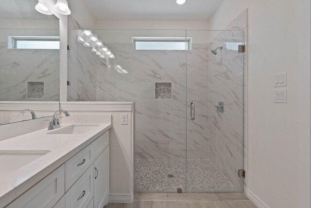 24696 Wicklow Rd, Hempstead, TX 77445 - bathroom featuring plenty of natural light, a marble finish shower, double vanity, and baseboards