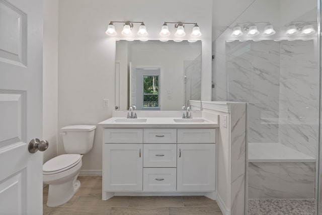 24696 Wicklow Rd, Hempstead, TX 77445 - full bathroom with a marble finish shower, double vanity, toilet, and baseboards