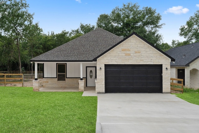 24696 Wicklow Rd, Hempstead, TX 77445 - view of front facade with roof with shingles, an attached garage, concrete driveway, and stone siding