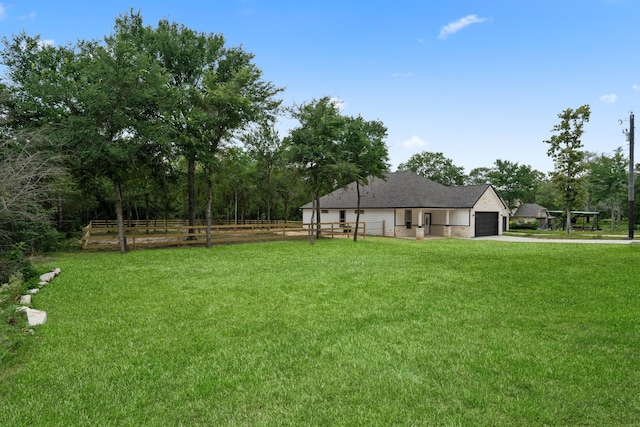24696 Wicklow Rd, Hempstead, TX 77445 - view of yard featuring concrete driveway and a garage