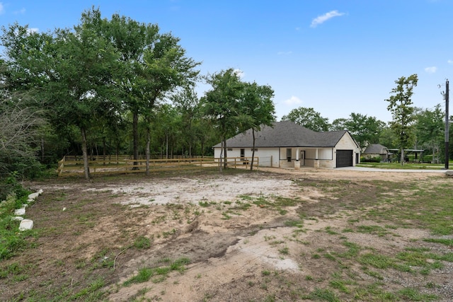 24696 Wicklow Rd, Hempstead, TX 77445 - view of yard with an attached garage and dirt driveway