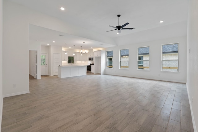 24696 Wicklow Rd, Hempstead, TX 77445 - unfurnished living room with light wood-style flooring, baseboards, a ceiling fan, a chandelier, and recessed lighting