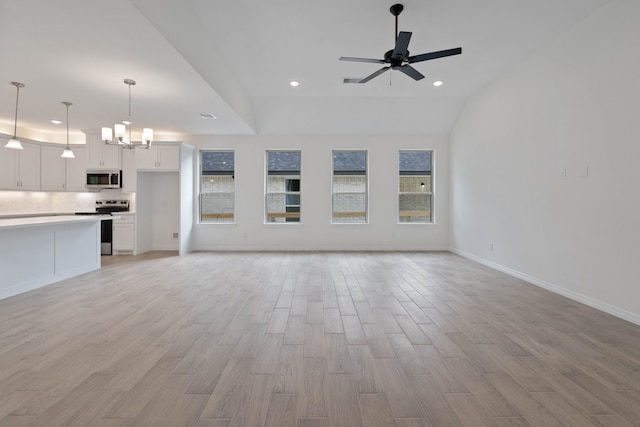 24696 Wicklow Rd, Hempstead, TX 77445 - unfurnished living room featuring light wood-type flooring, a ceiling fan, recessed lighting, baseboards, and a chandelier