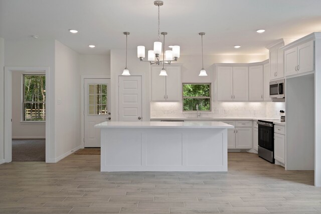24696 Wicklow Rd, Hempstead, TX 77445 - kitchen with appliances with stainless steel finishes, a sink, light countertops, tasteful backsplash, and a center island