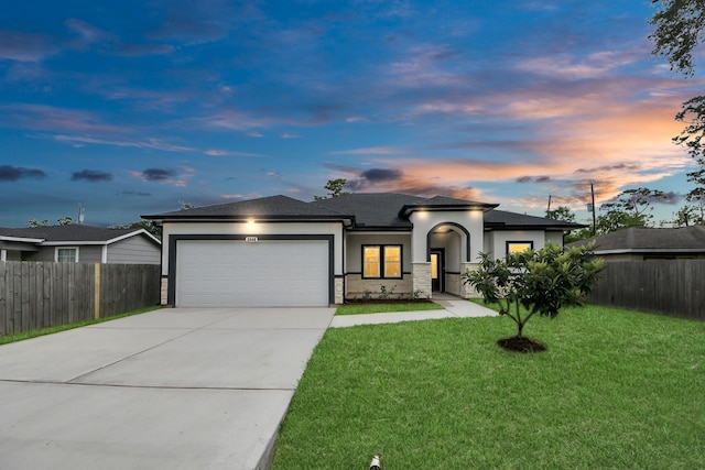 2448 Areba St, Houston, TX 77091 - view of front of home with an attached garage, concrete driveway, stone siding, stucco siding, and roof with shingles