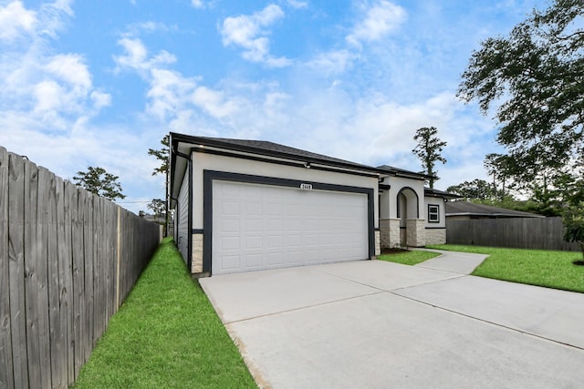 2448 Areba St, Houston, TX 77091 - view of front of house with concrete driveway, stone siding, stucco siding, and a garage