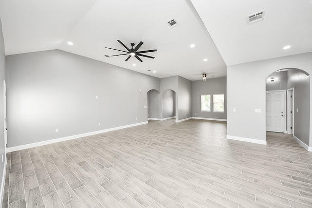 2448 Areba St, Houston, TX 77091 - unfurnished living room featuring a ceiling fan, arched walkways, recessed lighting, light wood-type flooring, and vaulted ceiling