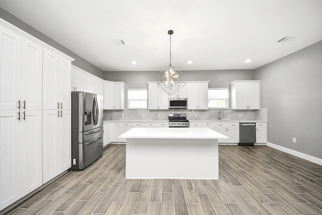 2448 Areba St, Houston, TX 77091 - kitchen featuring stainless steel appliances, a sink, light wood-style floors, light countertops, and white cabinetry