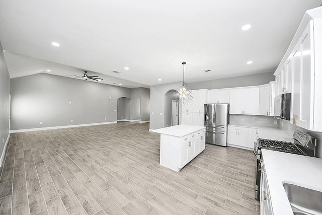 2448 Areba St, Houston, TX 77091 - kitchen featuring appliances with stainless steel finishes, ceiling fan, arched walkways, light countertops, and recessed lighting