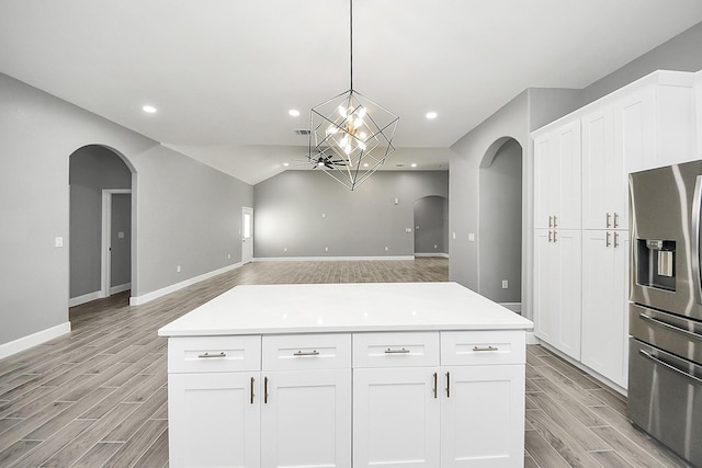2448 Areba St, Houston, TX 77091 - kitchen with stainless steel refrigerator with ice dispenser, arched walkways, light wood-type flooring, recessed lighting, and vaulted ceiling