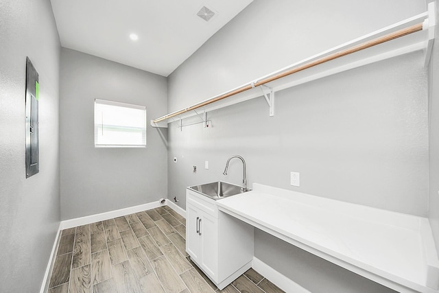 2448 Areba St, Houston, TX 77091 - washroom with cabinet space, washer hookup, baseboards, gas dryer hookup, and wood tiled floors