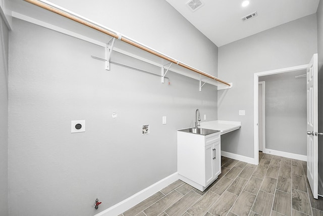 2448 Areba St, Houston, TX 77091 - washroom with hookup for a gas dryer, a sink, electric dryer hookup, and baseboards