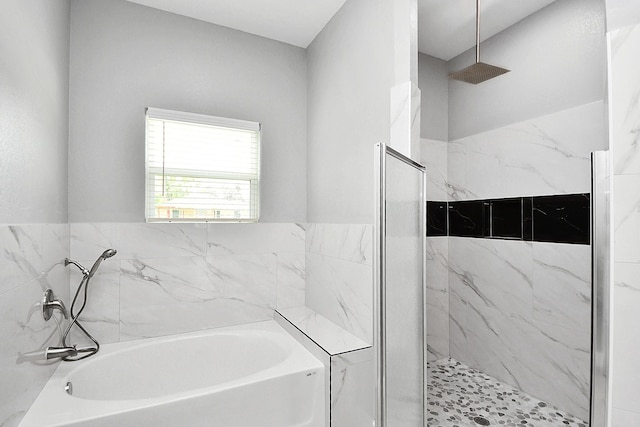 2448 Areba St, Houston, TX 77091 - full bathroom with a bath and a marble finish shower