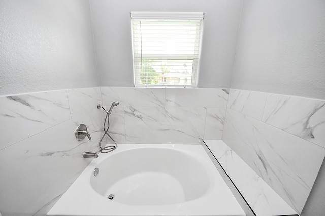 2448 Areba St, Houston, TX 77091 - bathroom with a garden tub and a textured wall