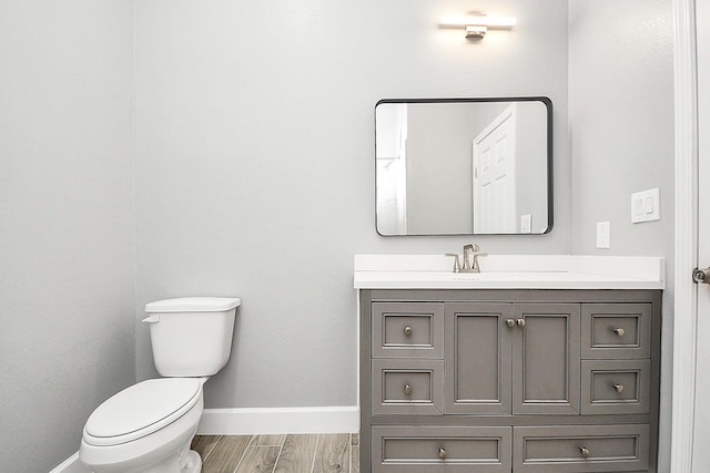 2448 Areba St, Houston, TX 77091 - bathroom featuring toilet, vanity, baseboards, and wood finished floors
