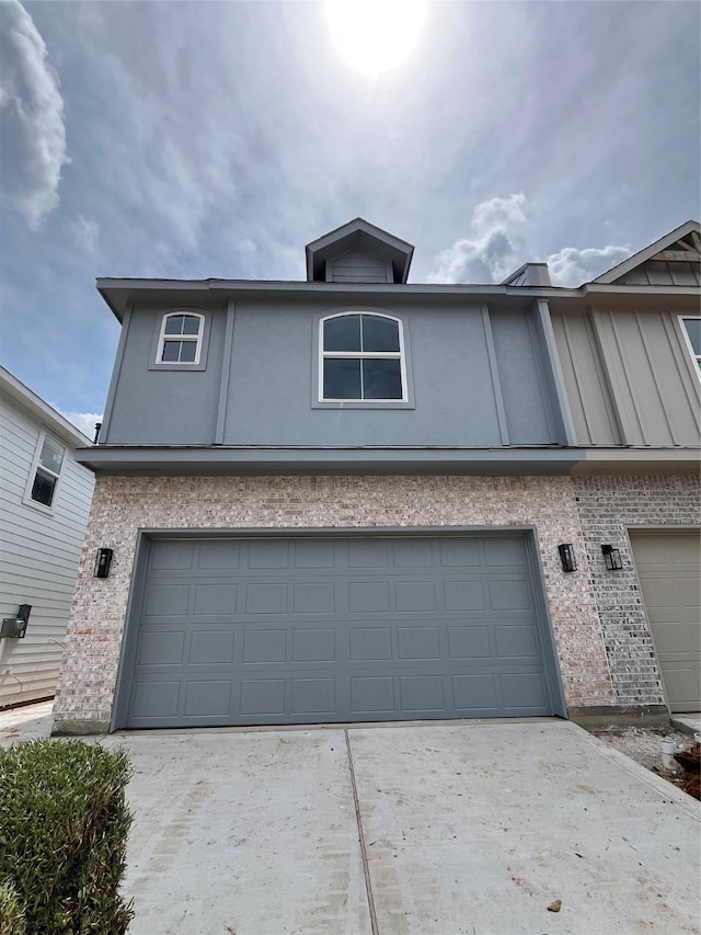 116 Capetown, Conroe, TX 77356 - view of front of property with brick siding, an attached garage, driveway, and stucco siding