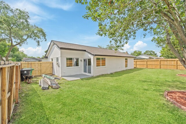 11819 Ryewater Dr, Houston, TX 77089 - rear view of house featuring brick siding, a patio area, and a shingled roof