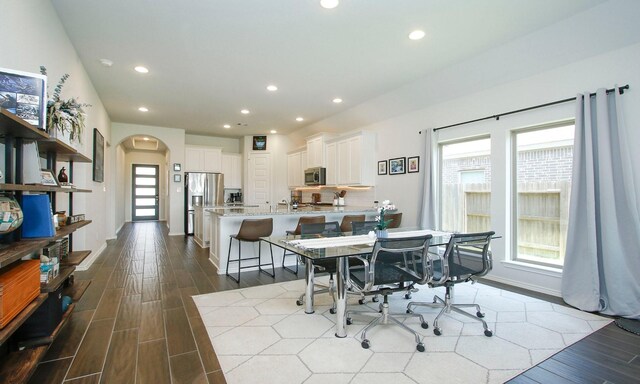 24618 Songlark Bend Dr, Tomball, TX 77375 - dining space with arched walkways, dark wood-type flooring, and recessed lighting