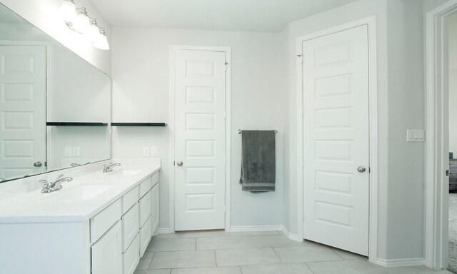 24618 Songlark Bend Dr, Tomball, TX 77375 - bathroom with double vanity, baseboards, and tile patterned flooring