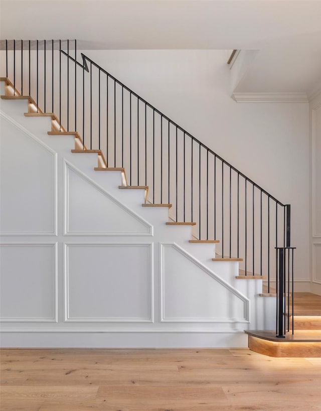 2218 Bartlett St, Houston, TX 77098 - staircase featuring ornamental molding and wood finished floors