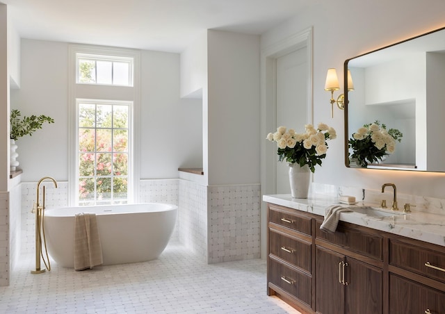 2218 Bartlett St, Houston, TX 77098 - full bath featuring tile walls, a wainscoted wall, vanity, and a soaking tub