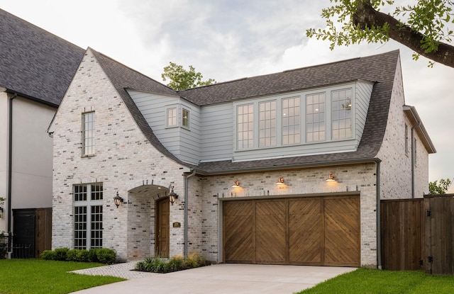 2218 Bartlett St, Houston, TX 77098 - view of front of house featuring a garage, driveway, brick siding, and a shingled roof
