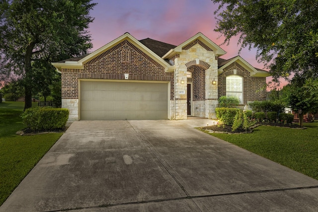 1079 Lake View Dr, Montgomery, TX 77356 - view of front of house with stone siding, an attached garage, concrete driveway, and a lawn