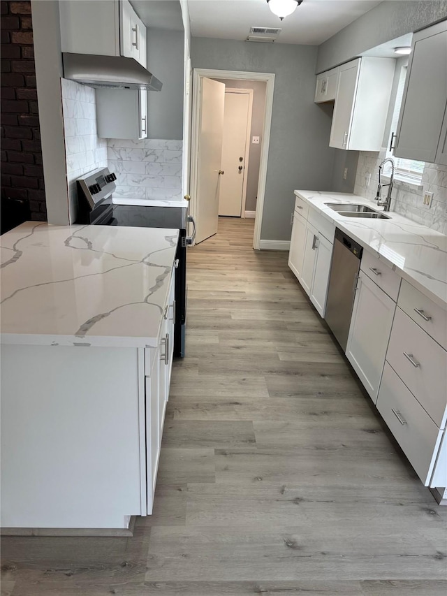 8818 Arbor Wood Dr, Houston, TX 77040 - kitchen with stainless steel appliances, custom exhaust hood, light stone countertops, and decorative backsplash
