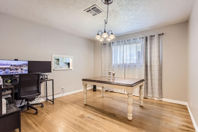 2401 Raspberry Ln, Pasadena, TX 77502 - office space with wood-type flooring, a chandelier, baseboards, and a textured ceiling