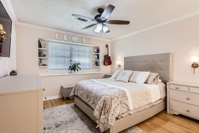 2401 Raspberry Ln, Pasadena, TX 77502 - bedroom featuring light wood-type flooring, ornamental molding, a ceiling fan, washer / dryer, and baseboards