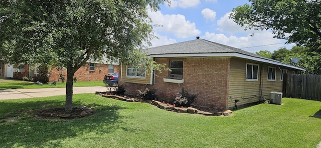 2401 Raspberry Ln, Pasadena, TX 77502 - view of home's exterior featuring brick siding, central AC, and driveway