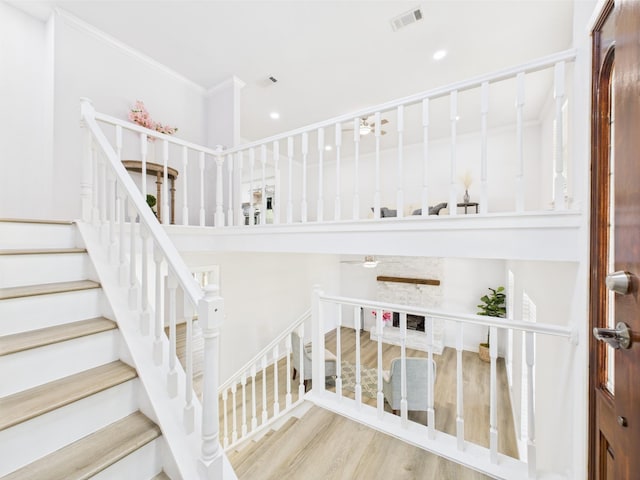 19503 Atascocita Shores Dr, Humble, TX 77346 - staircase with wood finished floors, crown molding, and recessed lighting