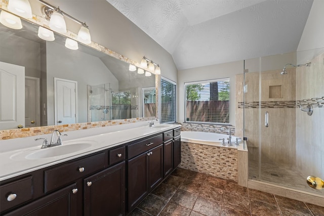 7931 Clarion Way, Houston, TX 77040 - bathroom featuring vaulted ceiling, a bath, a stall shower, and double vanity