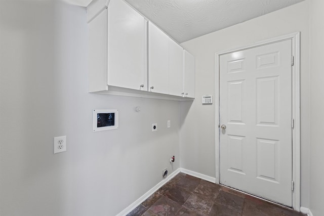 7931 Clarion Way, Houston, TX 77040 - laundry room featuring hookup for a gas dryer, hookup for an electric dryer, baseboards, cabinet space, and dark stone finish flooring
