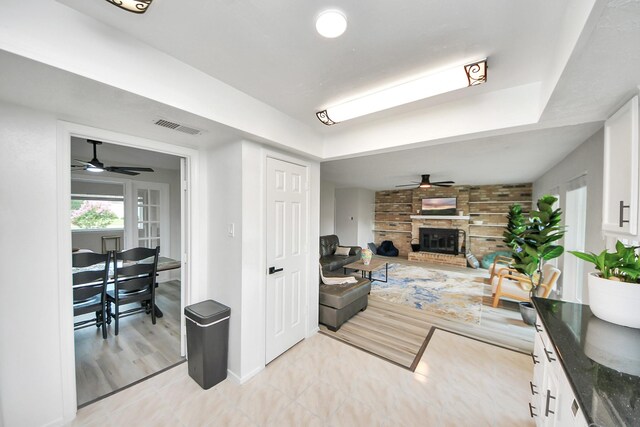 1902 Kings Arms Way, Katy, TX 77493 - living room featuring ceiling fan, a fireplace, and light wood-style flooring