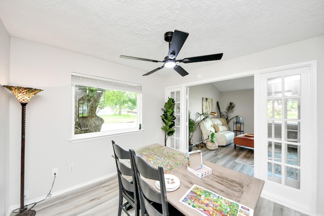 1902 Kings Arms Way, Katy, TX 77493 - dining space featuring light wood-style flooring, a textured ceiling, and a ceiling fan