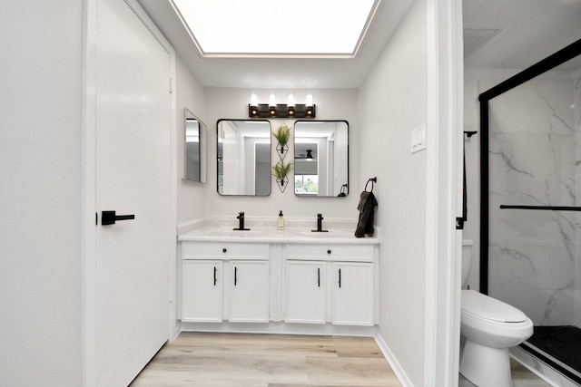 1902 Kings Arms Way, Katy, TX 77493 - full bathroom featuring double vanity, a marble finish shower, wood finished floors, and a skylight