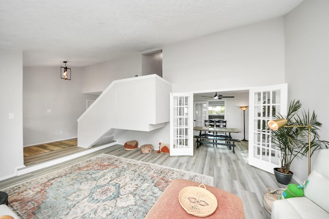 1902 Kings Arms Way, Katy, TX 77493 - living area featuring wood finished floors, french doors, stairs, and ceiling fan