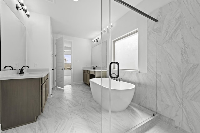 5049 Steady Breeze Dr, Katy, TX 77493 - bathroom featuring marble finish flooring, vanity, a freestanding tub, and a stall shower