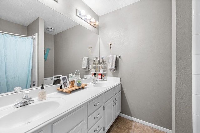 1602 Seminole St, Deer Park, TX 77536 - bathroom featuring double vanity, baseboards, tile patterned flooring, and curtained shower