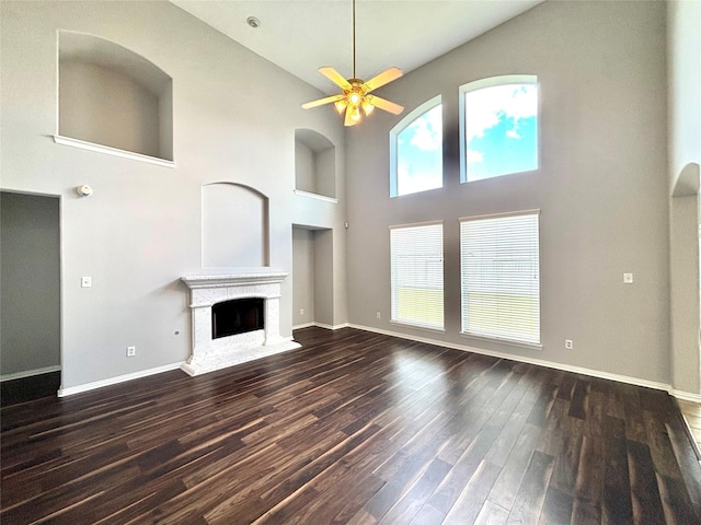 2528 Attwater Way, League City, TX 77573 - unfurnished living room featuring high vaulted ceiling, ceiling fan, baseboards, dark wood-type flooring, and a fireplace with raised hearth