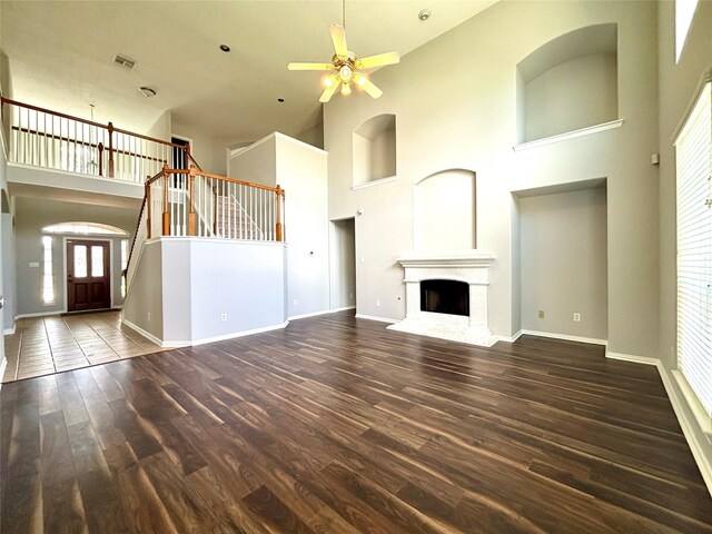 2528 Attwater Way, League City, TX 77573 - unfurnished living room with a towering ceiling, wood finished floors, ceiling fan, baseboards, and stairway